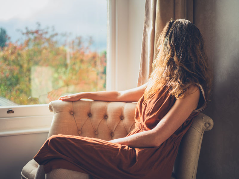 Woman sat in front of sash window